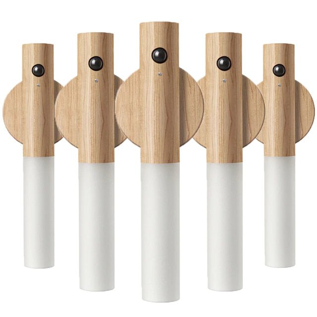 Set of five wooden cordless wall lights with white cylindrical bases on a white background