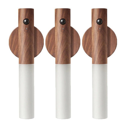 Three wooden cordless torches with white bases on a white background